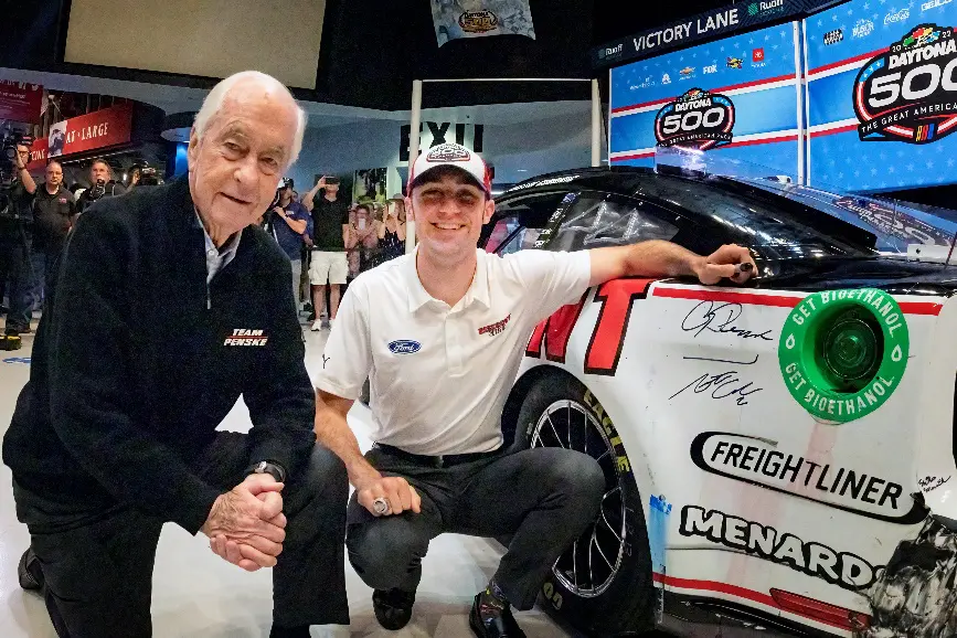 Austin Cindric poses by Team Penske Ford race car