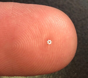 tiny part on fingertip for scale. KMM uses processes like hybrid CNC grinding to manufacture components like this