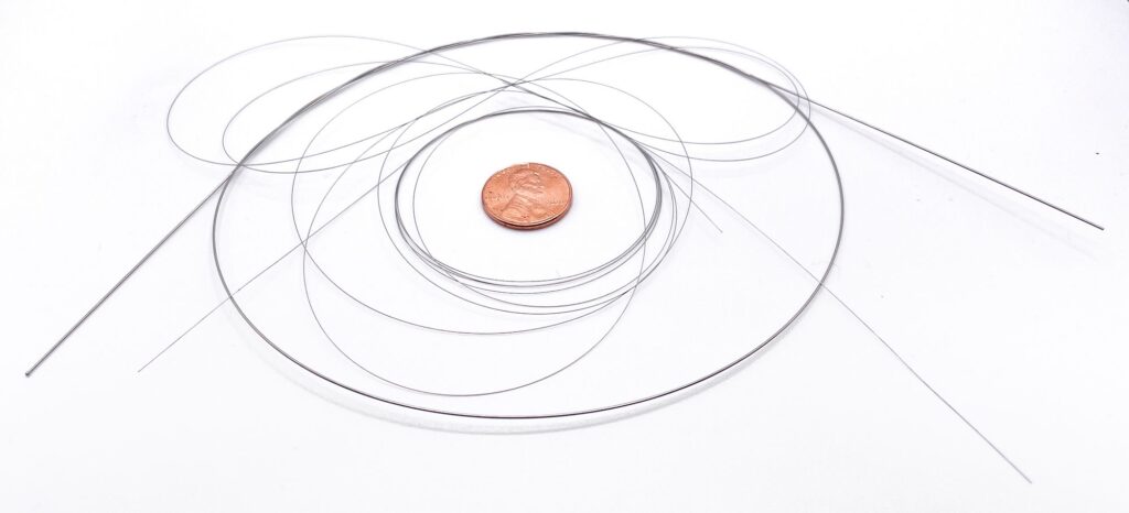 medical guidewire with penny for scale