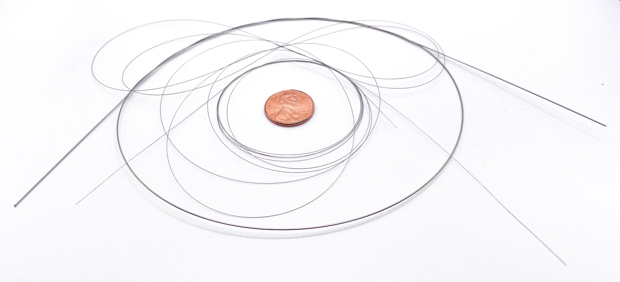 medical guidewire with penny for scale