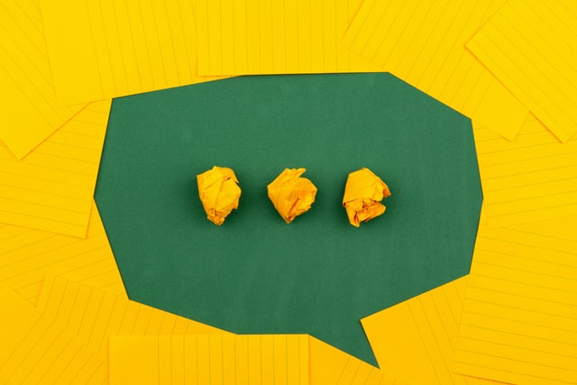 speech bubble formed from green and yellow paper