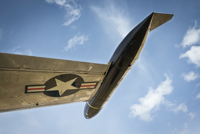 closeup of defense fighter plane wing against blue sky