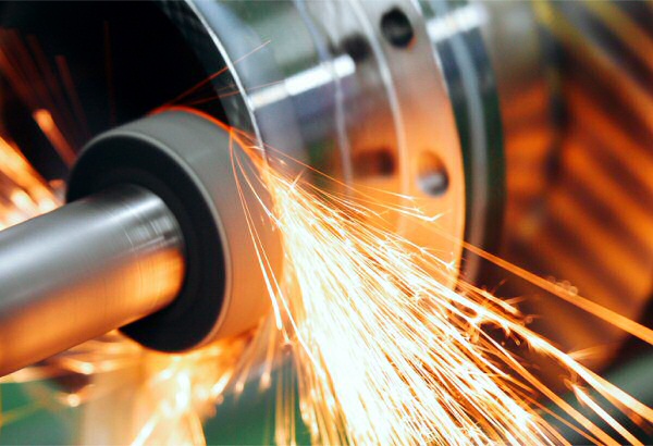 closeup of sparks flying from precision grinding machine